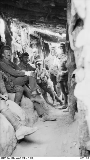 Australian troops, possibly including Private Gardner, back row, third from the left, relax inside a captured Turkish trench at Lone Pine.