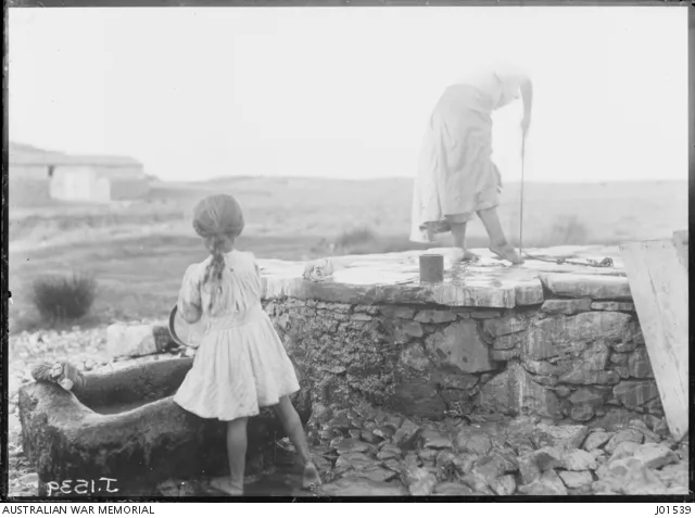 A Lemnian woman tests the water level in a stone tank on the island. 